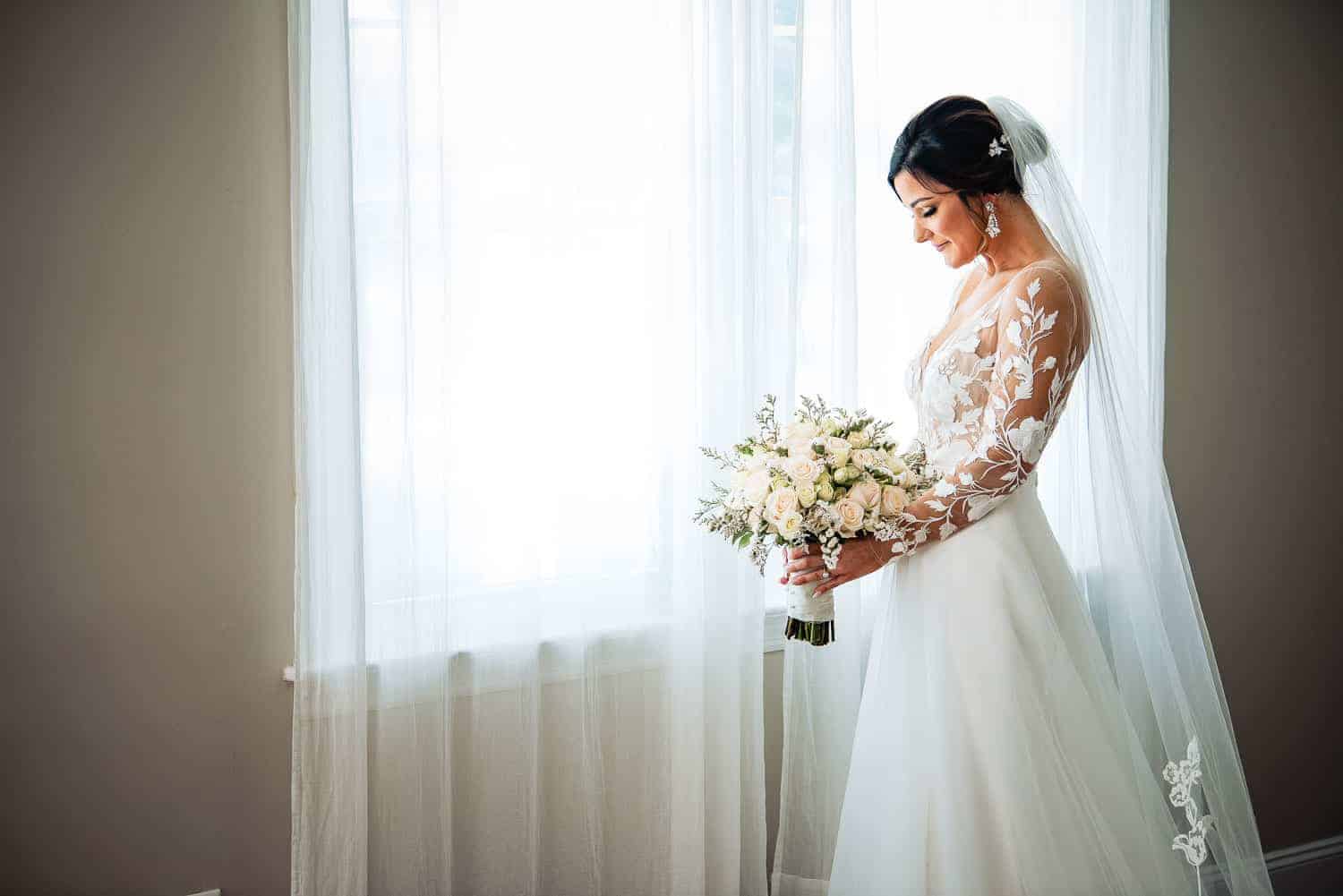 Bride by a window on wedding day