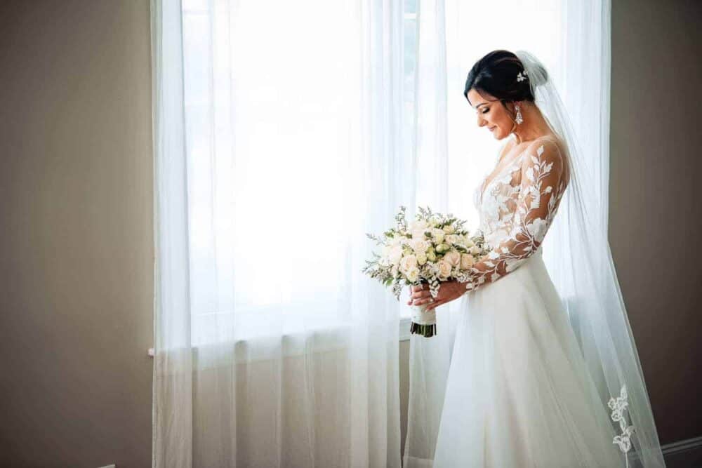 Bride standing by window