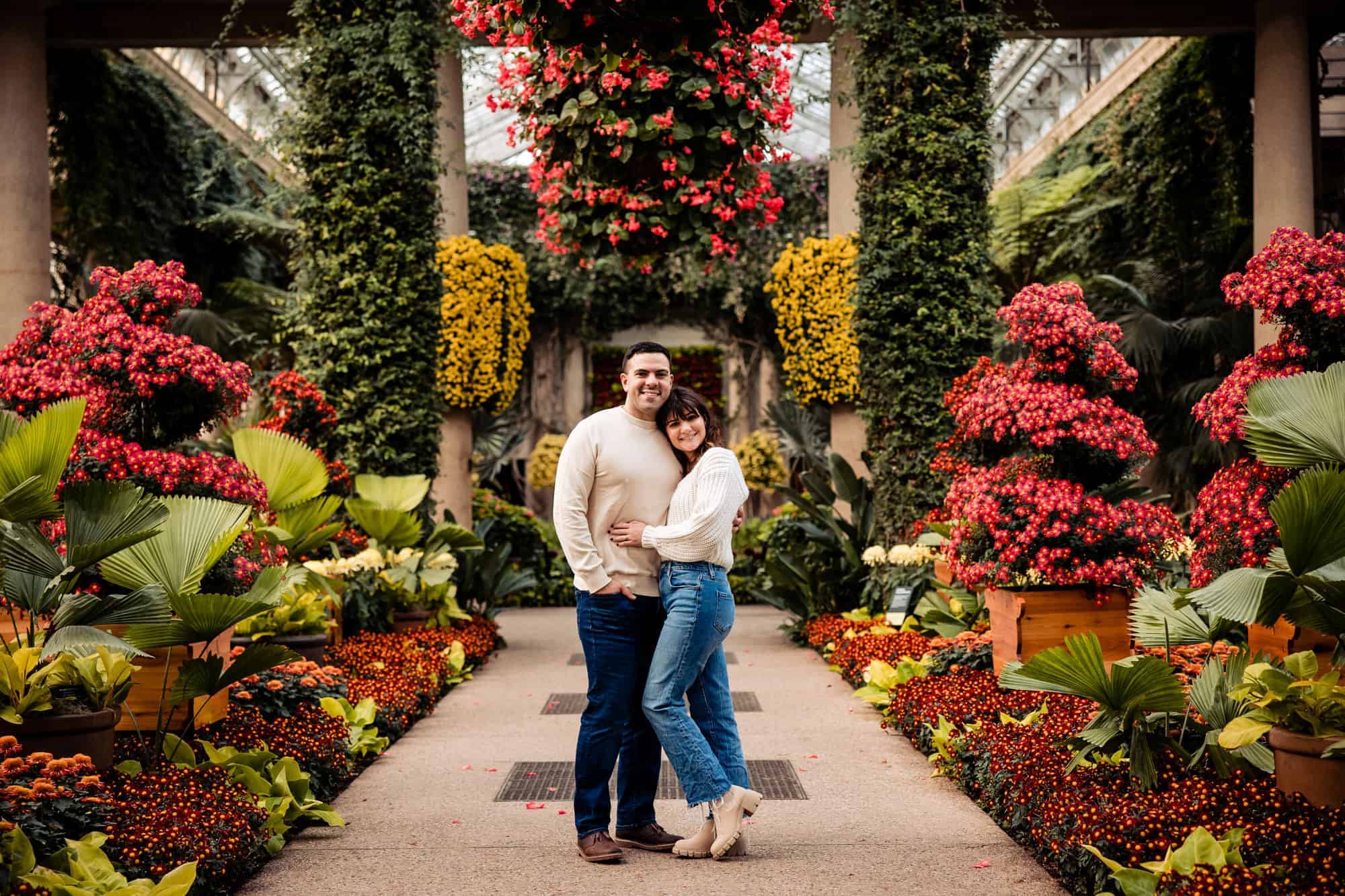 Engagement photo shoot at an indoor botanical garden or greenhouse.